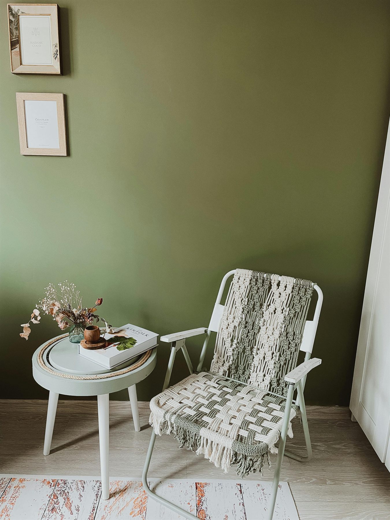 A calm, considered moment from the practice: a quiet room in soft natural light, with a chair, plants, and a green wall